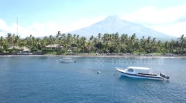2.7k Aerial View towards Tulamben Beach Diving Boats Mount Agung Volcano Bali