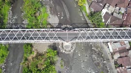 2.7k Aerial View from above Steel Bridge with Traffic and River Bali Indonesia