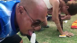 Weird party game in the Philippines sees people race to lick an ice lolly clean