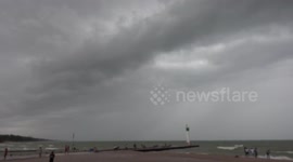 People flee the beach at Grand Bend Ontario Canada on the long holiday weekend as severe storm rolls in and the battle between spring and summer continues
