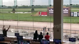 Crowds cheer on man running around course after storm cancels horse racing at Lonestar Park, Texas