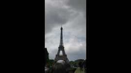 Man Dangles Off Side of Eiffel Tower