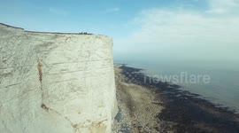 Drone camera spins and rolls in dizzying film of UK cliffside