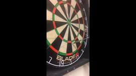 Two darts thrown and one lands in the other.