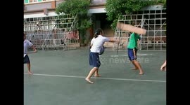 Thai students practice sword fighting during break time