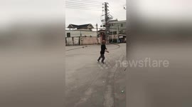 Chinese man exercises with giant metal hula-hoop