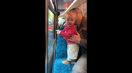 Baby tries to tell a very important story to strangers on the bus
