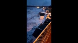 Terrifying moment dog walker gets smashed by huge waves crashing over sea wall in storm