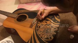 Time-lapse artist transforms a guitar into a piece of art with amazing ink skills