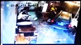 Mother and son escape injury after a car smashes into a restaurant in China