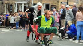 Carnage! Boozy competitors race around UK town in wheelbarrows