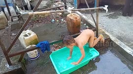 a 4-year-old boy in the field relaxes and swims in a baby bath