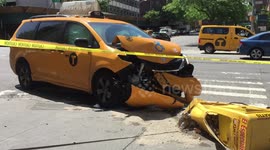 Taxi crashes into light pole and street sign