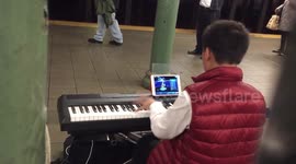 Child prodigy plays Mozart masterpiece while playing a computer game at the same time in New York, USA