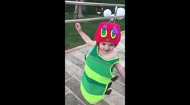 Cute toddler runs around dressed as the Very Hungry Caterpillar for book's 50th anniversary