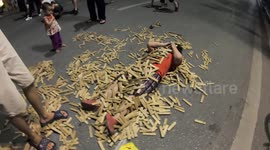 Fun moment! The child was buried in a pile of wooden building blocks toys on the street