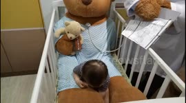 This baby is afraid of Doctor Teddy Bear