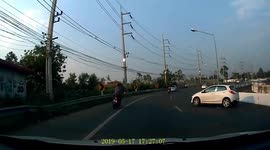 Thai motorcyclist miraculously avoids injury after car flips on top of him