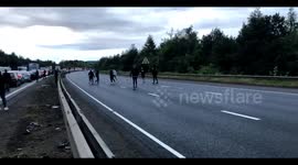 Football fans play kick-about during traffic gridlock on closed M1