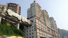 Elevated trainline runs through hole in building in China's Chongqing