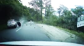Dramatic footage shows large boulder rolling down hill and smashing car in southeast Tibet