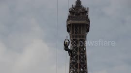 Brave thrill-seekers ride a 377-foot zipline off the Eiffel Tower