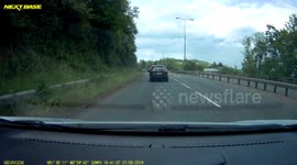 Speeding car spins on roundabout and rips bumper off