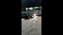 Motorists drive through heavy flash floods in the Philippines