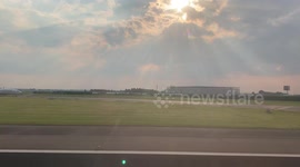 Beautiful sunbeams shine through clouds on takeoff from Amsterdam