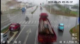 Chinese moped rider slides out of path of oncoming lorry in amazing near-miss