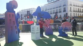 Fans snapped in front of Champions League Trophy exhibited at Puerta del Sol in Madrid, Spain