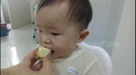Baby tastes durian for the first time