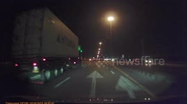 A close shave on the motorway between two trucks.