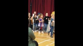 6 year old boy dancing at school concert