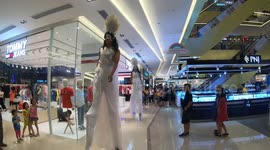 Interesting moment! Two men pretended to be women on stilts in the commercial center