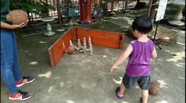 Kid playing coconut bowling