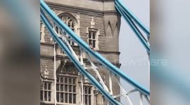 Unbelievable moment a 'naked' man appears to sunbathe on London's Tower Bridge