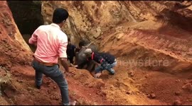 Indian villagers push struggling baby elephant out of 30-foot well