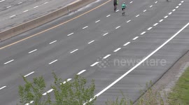 Empty highway through Toronto with people riding bikes on it instead of cars for a charity event on Sunday