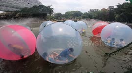 Children having fun in Plastic Bubble giant Balls - Playing and Walking on water !