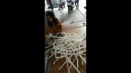 Women squeeze out 100-feet-length of rice crackers in Vietnam