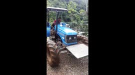 Honduran driver leaps to safety as tractor falls into raging river