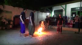 Great balls of fire! Barefoot boys at Indonesian boarding school play soccer with burning ball