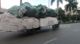 Ridiculously overloaded motorcycle cart carries 6m stack of foam boxes