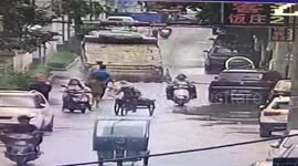 Transport lorry falls into sinkhole that opens up road in China