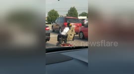 Man captures woman on mobility scooter waiting for turn signal on US road