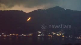 Lightning strike from storm ignites forest floor in India
