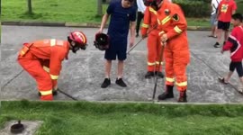 Firefighters break drain cover to get ID card back for student in China