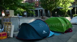 Homeless people camping in the avenue of el Prado in Madrid, Spain