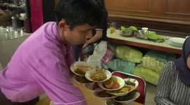 Best waiter in the world! Talented Indonesian restaurant worker balances FOURTEEN plates on one arm